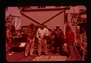 Image of Needleman and Capt. Reinhardt, U.S.S. Atka, discuss plans on deck 