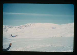 Image of C-130 ski-aircraft landing on snow covered Centrum Lake.