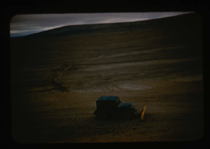 Image of Aerial view of dozing/levelling of airstrip surface by jeep with plow blade.