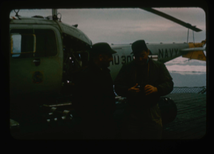 Image of Needleman discusses reconnaissance trip by helicopter with Captain Reinhardt