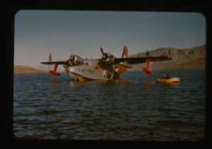 Image of Personnel are using raft to unload SA-16 aircraft which became mired in the mud