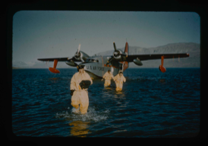 Image of Crew members leave SA-16 aircraft in special exposure suits in Centrum Lake.