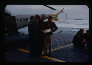 Image of Count Eigil Knuth, archaeologist, gov't.of Denmark, shows report to Atka crew