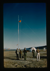 Image of Centrum Lake base camp flag raising ceremony as high tower (radio and meteor)
