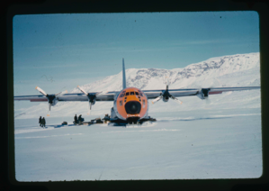 Image of C-130 aircraft off loads equipment, supplies in 4-6 feet of snow on Centrum Lake