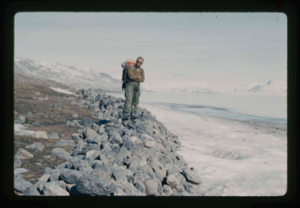 Image of Frank Maher standing on gravel pushed by Centrum Lake ice onto northwest shore.