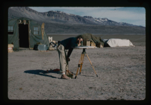 Image of Kinsellar, surveyor, is checking base line of airstrip from Centrum Lake Base
