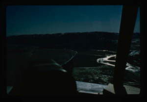 Image: Closer view of airstrip at Centrum Lake through window of helicopter. Ice cover