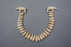 Image of Necklace w/tear-drop shaped segments and two small polar bears on each end.