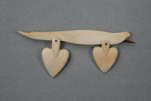 Image of Ivory pin with two heart shaped pieces dangling from the long ivory section