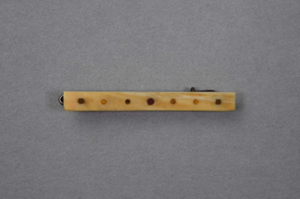 Image: Flat rectangular ivory hair clip with pattern of dots