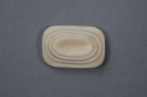 Image of Rectangular ivory pin w/3 levels of carved-out ovals. It is one piece