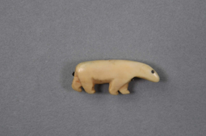 Image: Ivory polar bear pin with black eye and carved ear