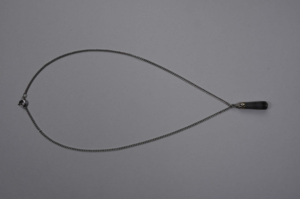 Image: Grey and black stone(?) oblong ornament on metal chain