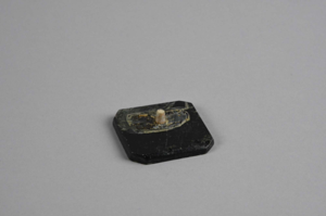 Image of Soapstone square with corners ground off and wooden peg - base for carving?
