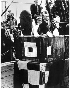 Image: Donald MacMillan at podium on a ship