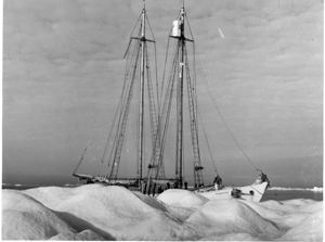 Image of The Bowdoin anchored to an iceberg