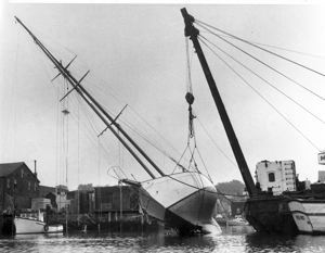 Image: Schooner Bowdoin on her side for repairs by a dock