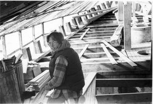 Image of Young woman carpenter on Schooner Bowdoin during reconstruction, planking