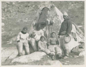 Image of In-you-gee-to, Too-cun-ah, and four children by their tupik
