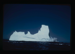 Image: Iceberg; surf breaking over one end
