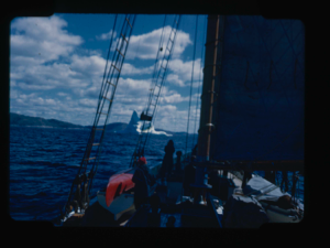 Image of Iceberg through rigging. Miriam MacMillan and crew on deck. Cloud effect.