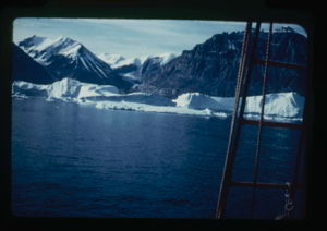 Image of Icebergs, mountains and ice cap seen through rigging