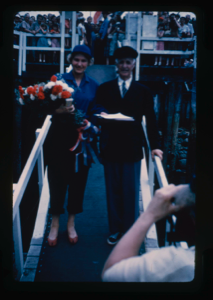 Image: Donald and Miriam MacMillan on gang plank with citations and bouquet (2 copies)