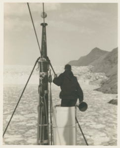 Image of MacMillan in ice barrel near glacier face