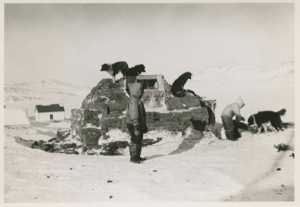 Image: Eskimos [Inuit] by their sod house