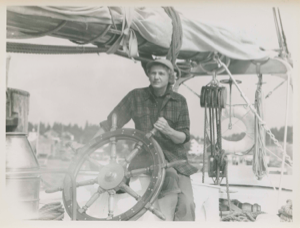 Image of Miriam MacMillan at wheel of schooner Bowdoin