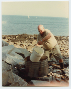 Image of Man preparing lobster bake at the shore