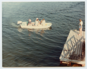 Image of Group in motorboat approaching float