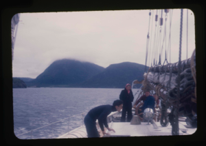 Image of Miriam MacMillan and two crewmen on deck. 