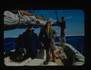 Image of Donald MacMillan and crewmen on the Bowdoin. Ice pack beyond.