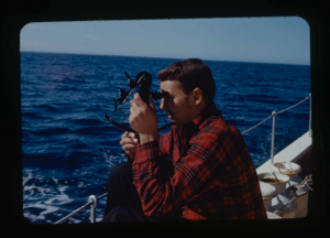 Image: Stan Cook taking a sight with theodolite [sextant]