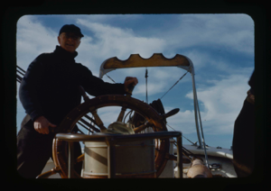 Image of Donald MacMillan at wheel (2 copies)