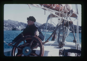 Image of Donald MacMillan at wheel (2 copies)