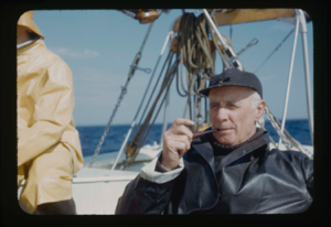 Image: Donald MacMillan sitting on deck with pipe (2 copies)