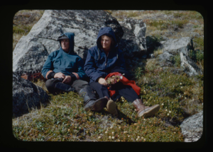 Image of Miriam and Donald MacMillan sitting among Arctic flora (2 copies)
