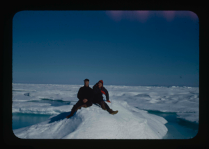 Image of Miriam and Donald MacMillan sitting on ice floe  in Kane Basin(2 copies)
