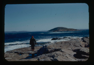 Image of Miriam MacMillan walking on rocky shore