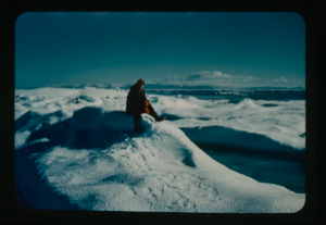 Image of Miriam MacMillan sitting on iceberg (3 copies)