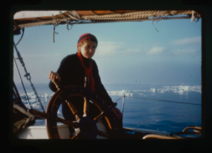Image of Miriam MacMillan at wheel; ice field beyond (2 copies)