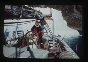 Image of Miriam MacMillan at wheel. Iceberg beyond. (2 copies)