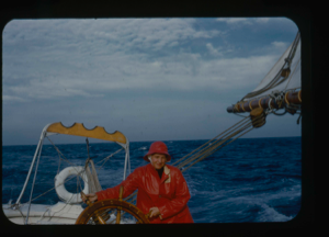 Image of Miriam MacMillan at wheel in rain gear