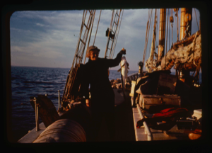 Image of Miriam MacMillan on deck with codfish caught on jig (2 copies)