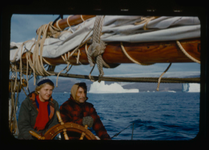 Image of Kali Peary and Miriam MacMillan at wheel. Iceberg beyond