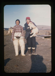 Image of Miriam MacMillan holding dog, and Inuit woman