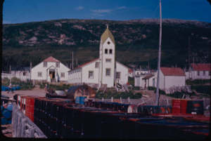 Image of Moravian church in Nain. Oil barrels on dock.